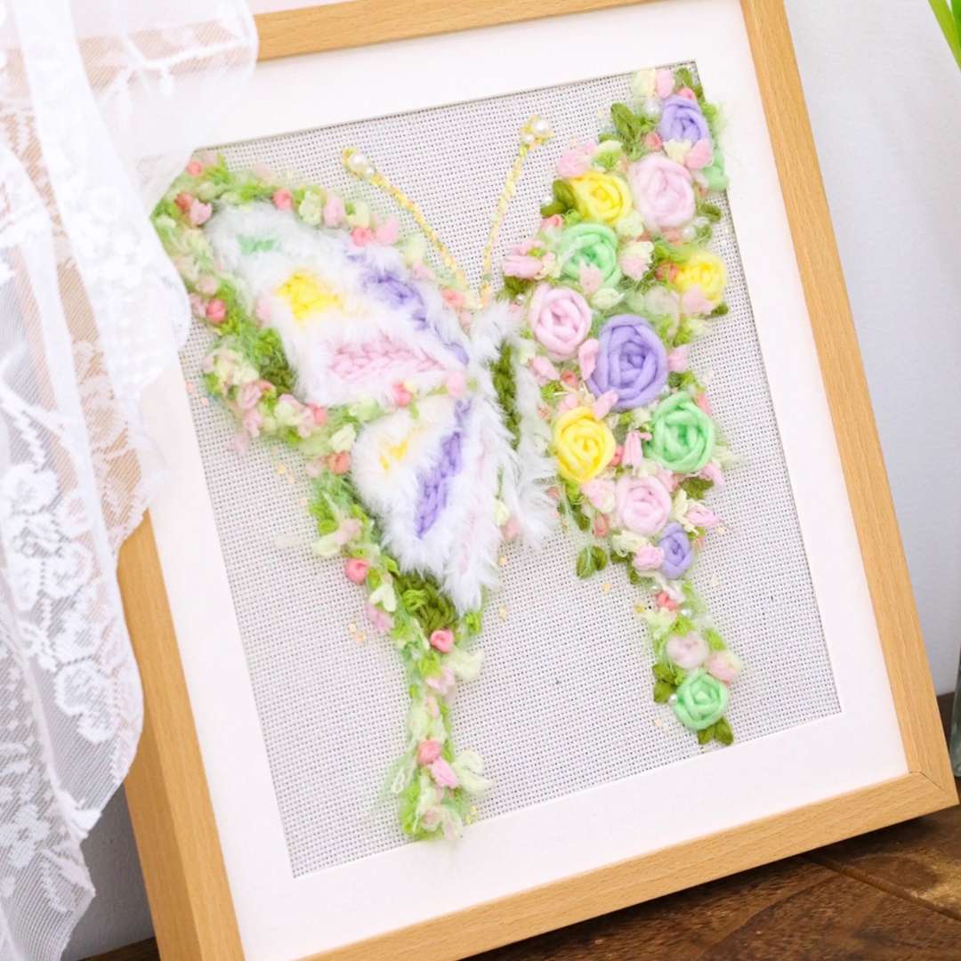 Puddingcase punch needle kit featuring a green butterfly design adorned with pastel floral accents, ideal for DIY embroidery and home decor projects.
