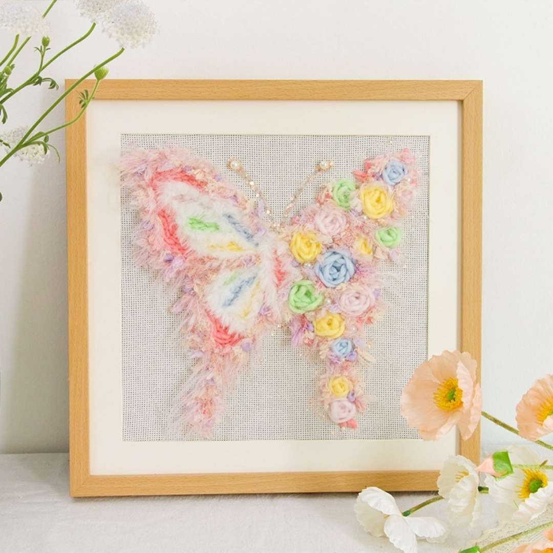 Puddingcase punch needle kit featuring a pink butterfly with pastel floral embellishments, ideal for DIY embroidery and home decor projects.